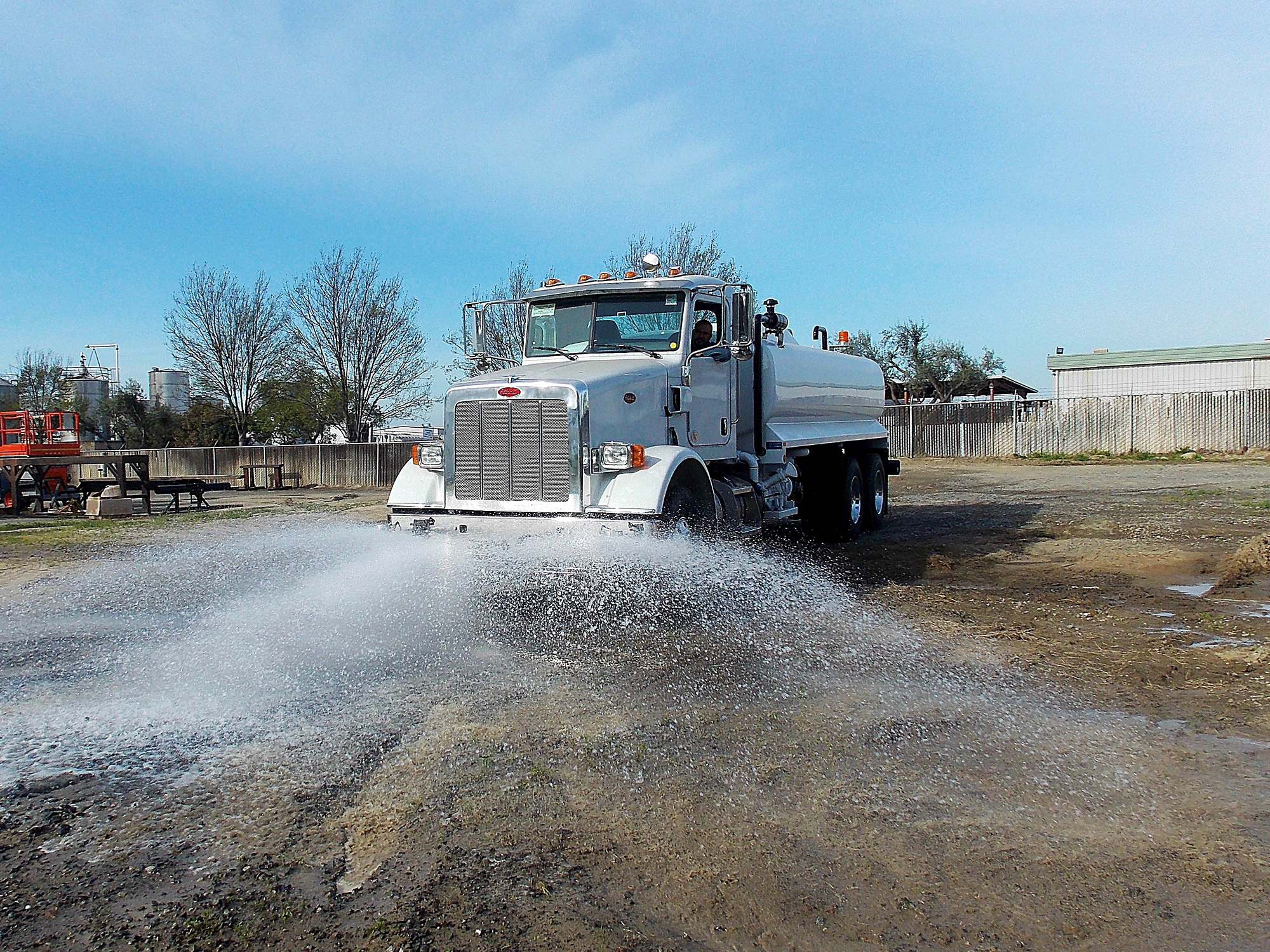 McLellan water truck distributing water
