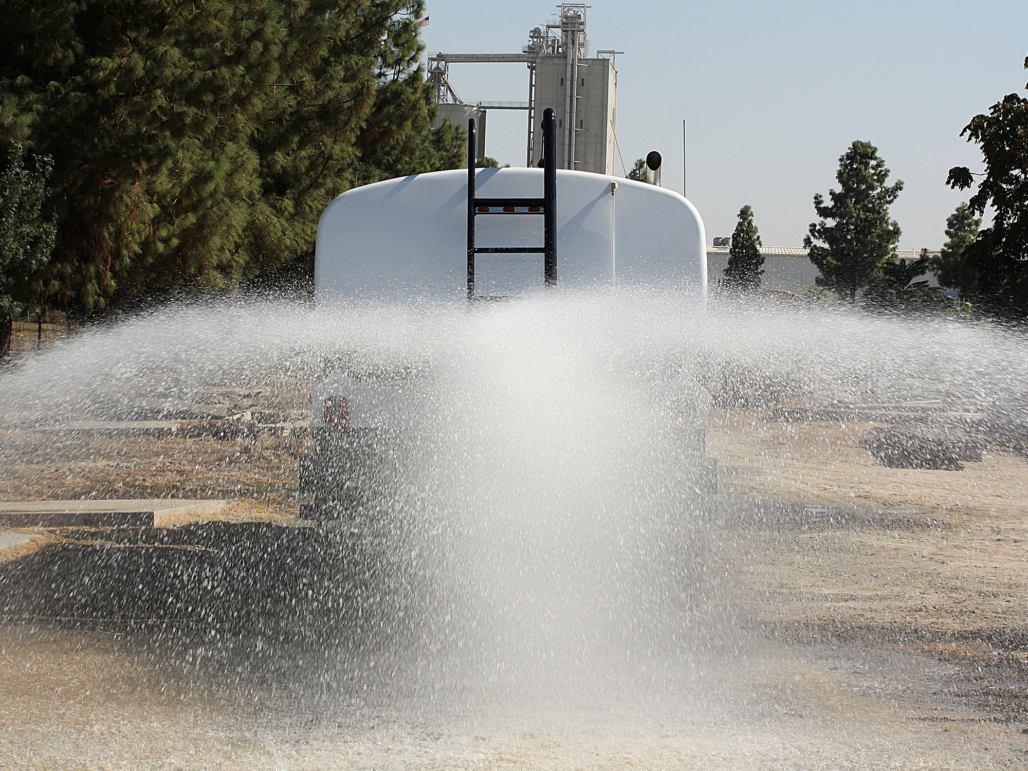 McLellan water truck distributing water